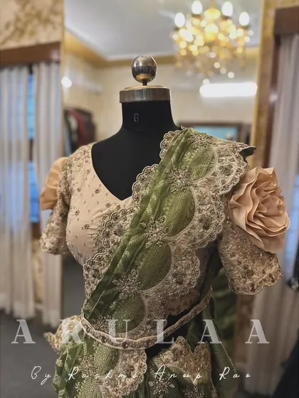 A closer look at the reception saree, highlighting the 3D fabric rose on the sleeve and the intricately embroidered belt.