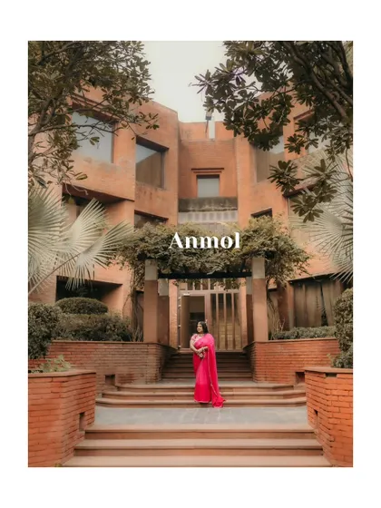 An artistic portrait of the bride before her haldi ceremony, framed by the trees and architecture of the venue.