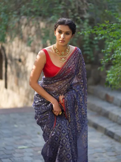 A beautiful shot of a model in a classic navy blue and red saree. This is from a collaboration where we focused on creating a timeless and elegant look.