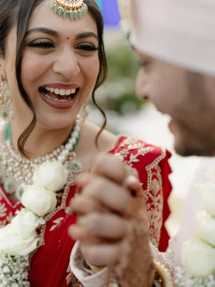 A close-up of pure joy. This candid moment captures her laughter, and her makeup looks fresh and perfect, designed to move with her and last all day.
