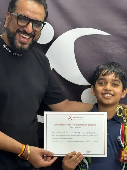 The joy of victory is clear on the faces of our coach and this young Under-15 player, who holds his certificate and trophy after placing 3rd in a highly competitive tournament.