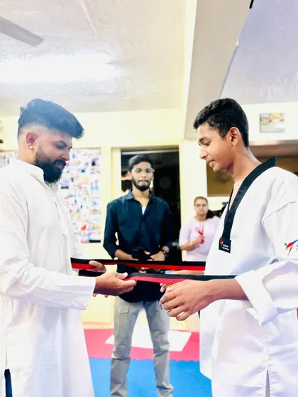Presenting the red and black belt to a deserving student.