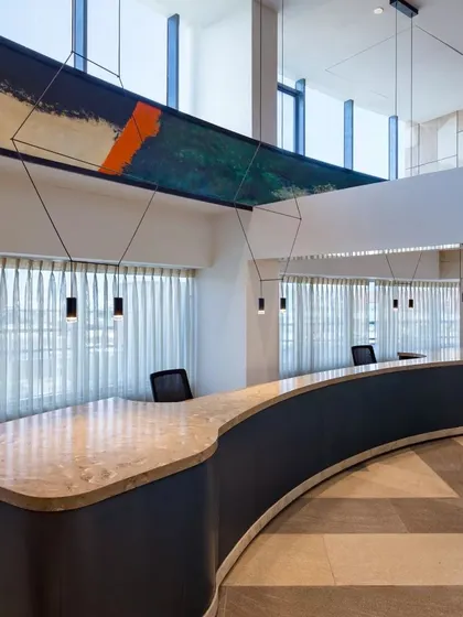 The reception lobby at Conscient One, where hand-painted beams serve as a striking artistic focal point. This project demonstrates how art can be integrated into the core of a design to create luxury and charm on a budget.