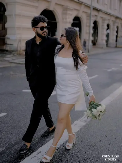 Walking arm in arm, they share a look that feels both candid and cool. This shot, taken as they cross the street, has a natural, unposed quality that I strive for in my urban pre-wedding photography sessions.