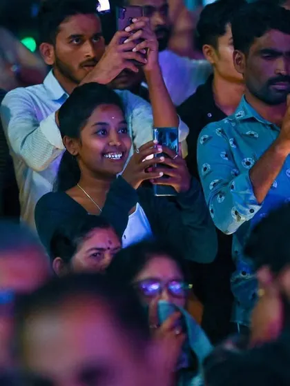 The audience at the Bengaluru Ganesh Utsava, capturing the moment on their phones. It's amazing to see how music brings people together in celebration.