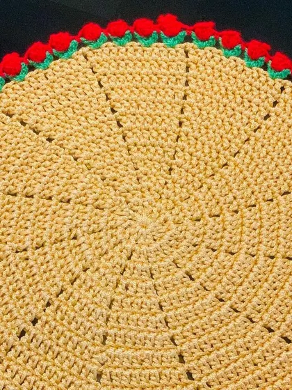 A yellow doily with a festive red tulip border. This color combination is great for celebrations.