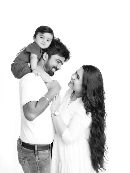 The black and white version of the family portrait. This edit gives the image a classic, artistic feel, focusing on the light, emotion, and composition.