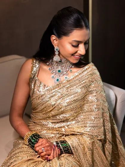 A candid moment of quiet confidence. The soft glam makeup and sleek hair create a look that is both modern and timeless.