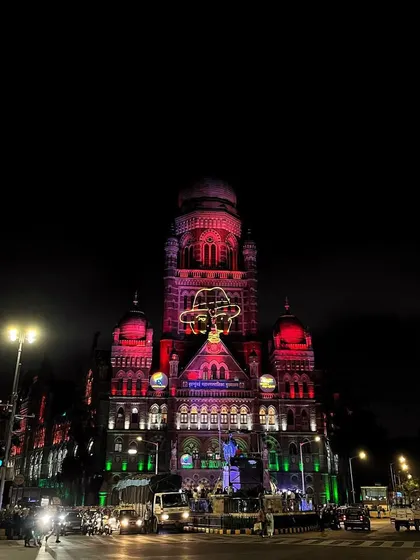 The BMC building illuminated at night for Independence Day, with a projected image of Mahatma Gandhi on its facade.