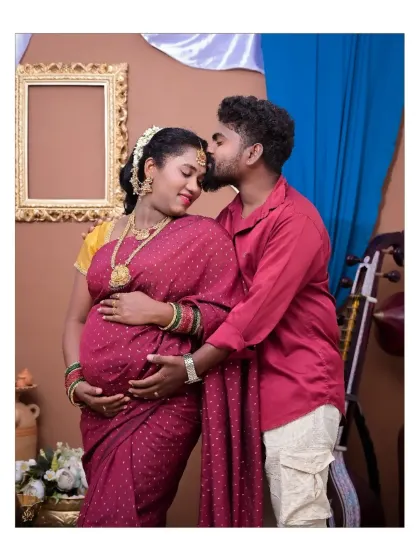 An intimate couple's portrait within our traditional theme. The gentle kiss on the forehead is a timeless expression of love and protection, beautifully captured in this culturally rich setting.