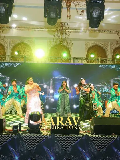 A big family group performance on stage. I love choreographing these large numbers, ensuring everyone is synchronized and the stage is filled with joyous, coordinated energy.