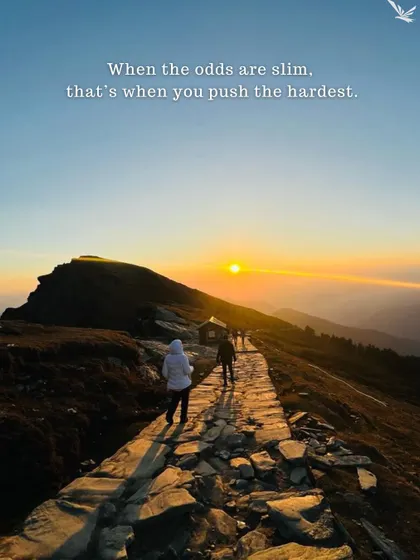 When the odds are slim, that's when you push the hardest. Trekkers walking on a path towards the sunset.