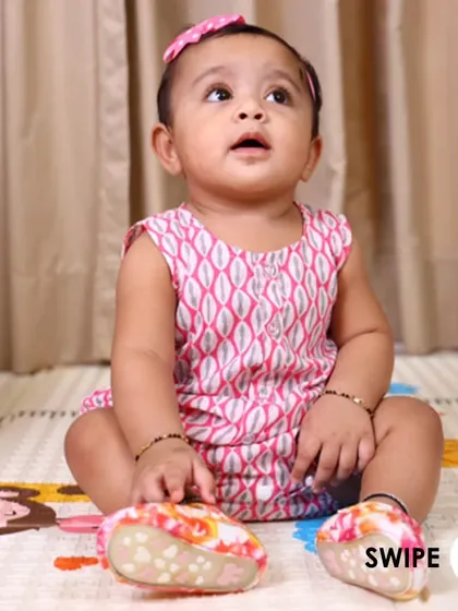 Another view of the pink printed romper, showcasing its comfortable and functional design for everyday wear.
