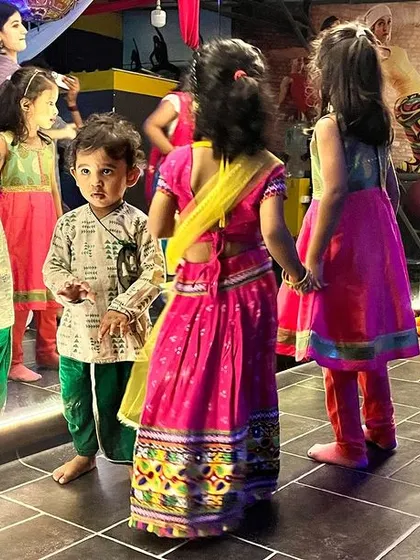 Our youngest students, dressed in beautiful traditional outfits, getting ready to join the Dandiya dance. We make sure even the little ones feel included in our festival celebrations.