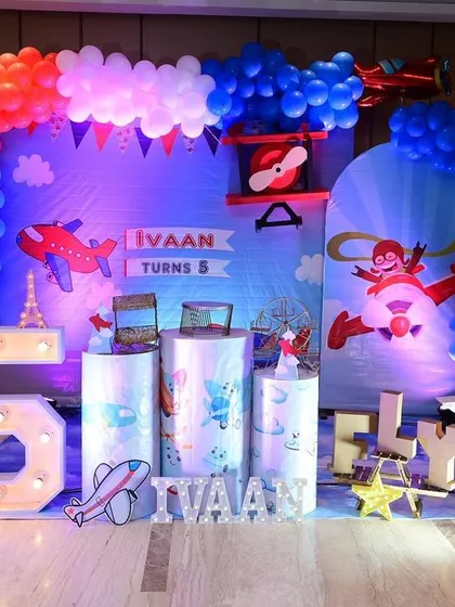 An airplane themed 5th birthday party we catered for. The decor, from the backdrop to the light-up numbers, was all designed to create a fun 'fly high' experience.