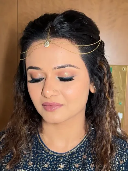 Another close-up of the eye makeup, showing the blend of soft shimmer and liner. The lashes are full and fluttery, completing the dramatic effect.