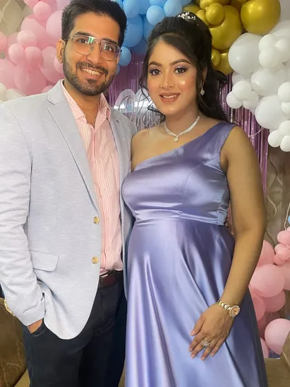 The happy couple, ready to celebrate their baby shower. Her makeup is soft, pretty, and picture-perfect.