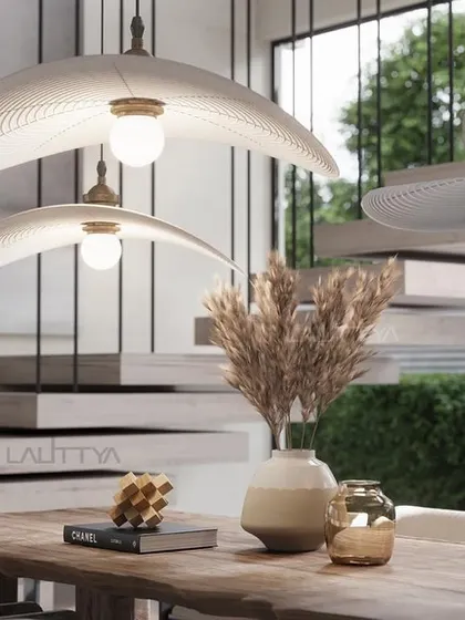 A view of one of our elegantly styled dining rooms. We focus on combining statement lighting, comfortable seating, and high-quality materials like marble and brass to create spaces that are perfect for both everyday meals and special occasions.