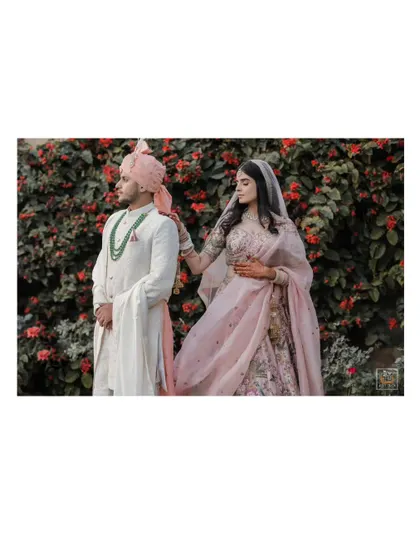 A romantic portrait of the couple against a backdrop of lush greenery in Jaipur.