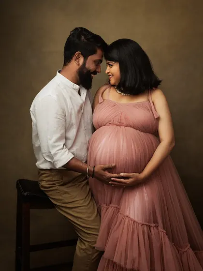 An intimate moment between an expecting couple, their foreheads touching as they share a quiet connection. This is a classic pose for fine art maternity photography.