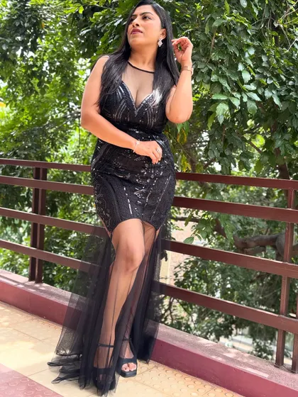 Another look at my black sequin dress, showcasing its elegant silhouette. I believe that looking the part is essential to creating a high-end atmosphere for any special occasion.