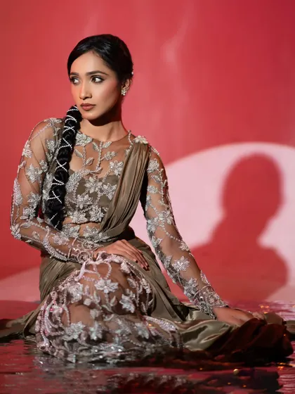 A closer look at the intricate silver embroidery on the fusion gown. The floral patterns were carefully placed to flatter the body, and the sheer fabric adds a touch of delicate elegance to the overall red carpet look.