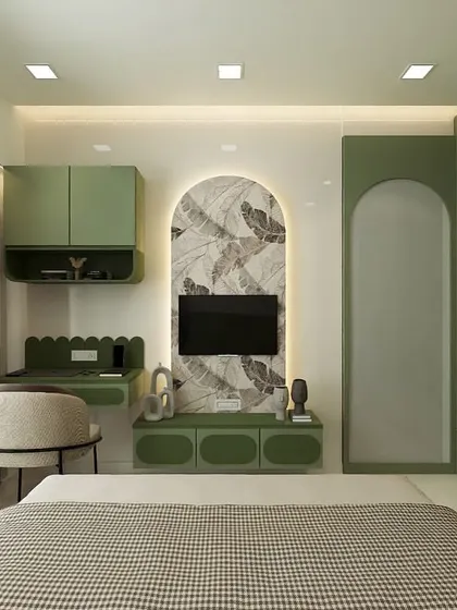 This bedroom combines a soft green color with natural wood tones. We designed a custom unit that includes a scalloped-edge study desk and a TV console set within a wallpapered arch, creating a beautiful and functional feature wall.