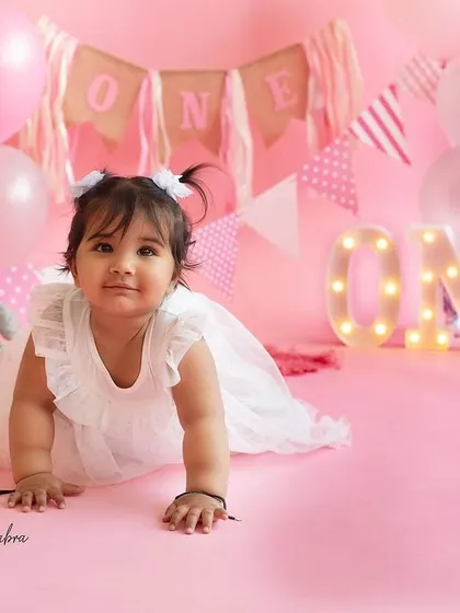 One of the twin girls exploring the set during her first birthday shoot. These crawling shots are a perfect way to remember this active and curious stage.