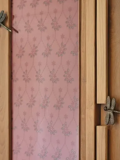 A close-up of a custom wardrobe, showcasing a blend of materials and artisanal details. The dragonfly handles, patterned fabric panel, and natural cane weave demonstrate my commitment to creating unique, tactile surfaces and celebrating fine craftsmanship in every piece.
