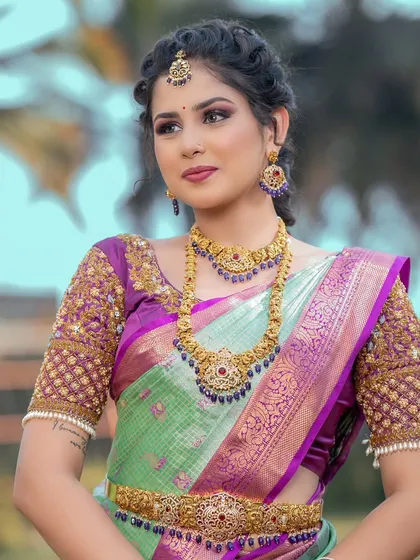 A lovely combination of a temple choker and a longer necklace with blue stone accents. This shows how you can mix traditional designs with a hint of color.