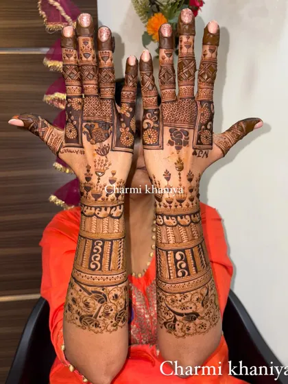 A traditional back of hand mehendi design with lots of beautiful, intricate details.