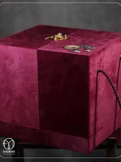 The complete presentation of the Sufi-themed Rajwada Chest. The rich magenta velvet box with its custom monogram is a statement of pure luxury, promising an equally special gift inside.