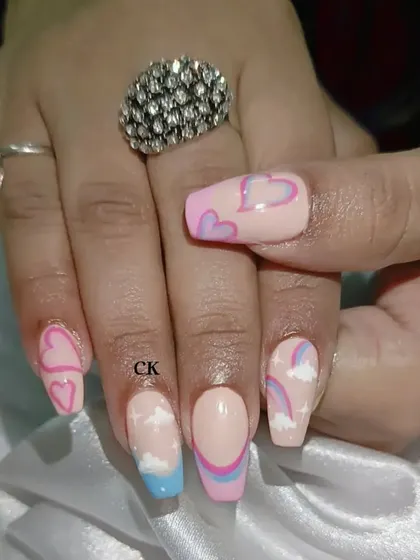 A close-up of the hand-painted hearts and clouds design.