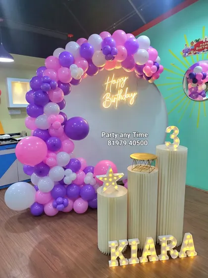 A pretty purple and pink balloon arch setup for Kiara's 3rd birthday party.