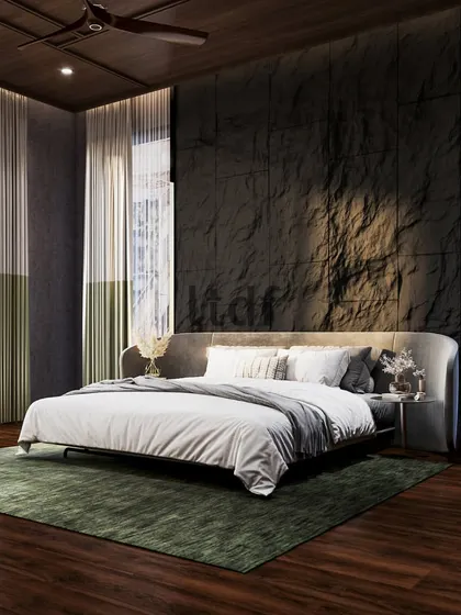 Surrounding yourself with natural elements fosters tranquility. This bedroom makes a powerful statement with a rocky, tactile feature wall, emulating strength and roughness. This is balanced by the comforting touch of wooden flooring and soft natural light from full-height windows.