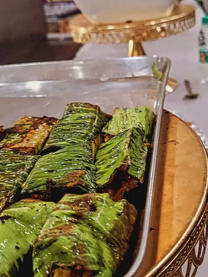 This is a close-up of my special paneer appetizer wrapped and grilled in a banana leaf. It's a unique and flavorful starter that showcases a different style of vegetarian cooking.