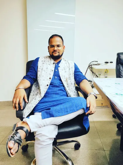 In my office, where strategy takes shape. Whether in traditional Indian attire or a Western suit, my focus remains the same: crafting the best possible outcomes for my clients.