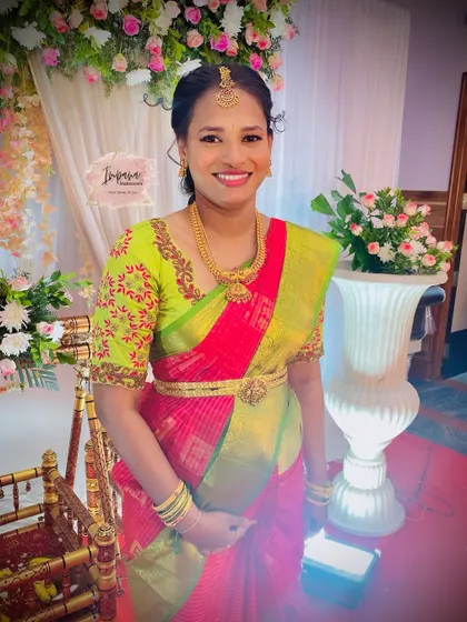 A beautiful new mother at her child's naming ceremony. Her makeup is fresh and bright, reflecting the joy of the occasion.