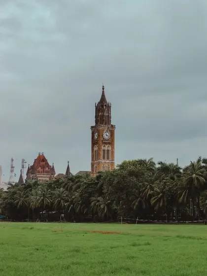 The Rajabai Clock Tower seen from Oval Maidan, a classic view of South Mumbai's green lung.