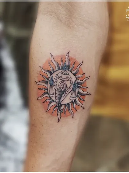 Another view of the Ganesha sun mandala tattoo, highlighting the detailed line work and the vibrant color.