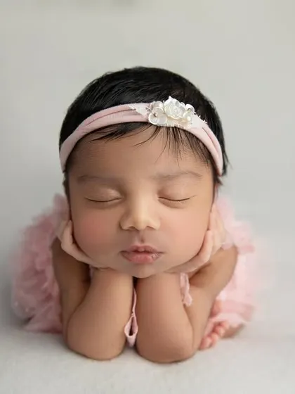 The 'chin on hands' pose with a sweet pouty lip expression. These fleeting moments are what I aim to capture in every session.
