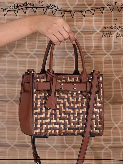 The Little Perry satchel in our signature Madurai weave. The tri-color woven panel on the front adds a beautiful, artisanal touch to this structured and classic bag shape, making it a standout piece.