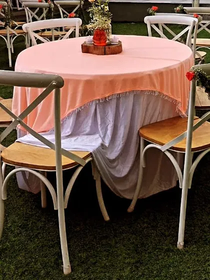 Another view of the beautiful table settings for a wedding event we catered. The cross-back chairs and pastel linens create a rustic yet elegant atmosphere.