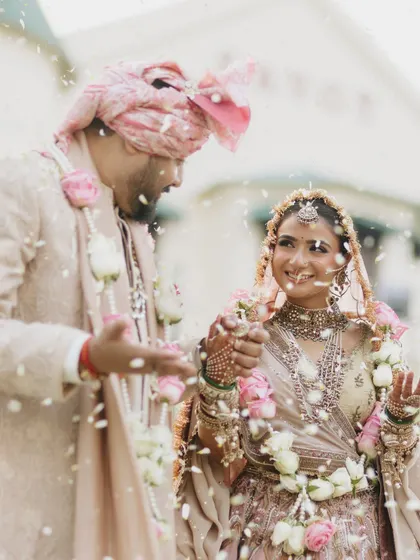The happiness of the varmala ceremony. Vasav's makeup is fresh and luminous, perfect for a daytime wedding.