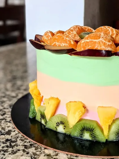 A duplicate of ID 112, this is a close-up of the fresh fruit cake, showing the juicy oranges and plums.