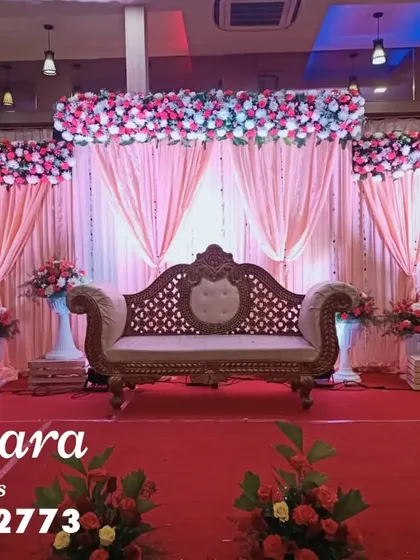 A classic stage setup with pink floral arrangements and elegant drapery. This versatile design is perfect for engagements, receptions, or anniversary celebrations, offering a timeless look.