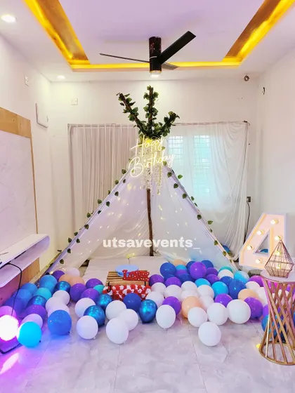 A close-up of the canopy tent from the home birthday setup, adorned with fairy lights and greenery, making it a perfect little hideaway for the celebration.