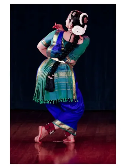 The back view of Chaitra Rao's costume, highlighting the traditional pleats and ornamentation. The visual aesthetics are an integral part of a complete Margam presentation.