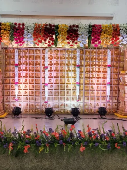 For clients who want to go all out, I designed this grand, temple-themed stage for a baby shower. The backdrop features hundreds of small bells, framed by large pillars and topped with a thick canopy of multi-colored flowers.