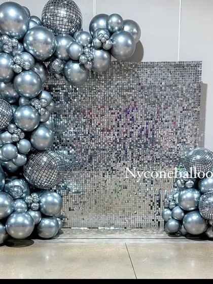 I brought the disco fever with this all-silver party theme. The centerpiece is a reflective silver sequin wall, framed by a chrome balloon arch that includes mini disco ball details for that extra sparkle.